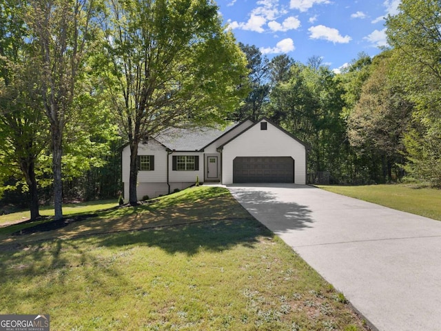 single story home with an attached garage, a front lawn, and driveway