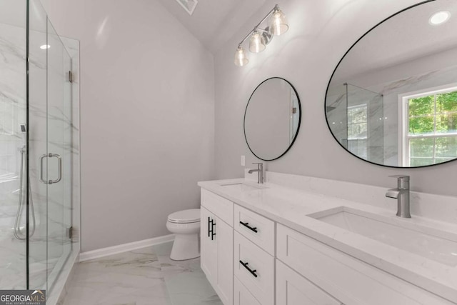 bathroom featuring marble finish floor, toilet, a marble finish shower, and a sink