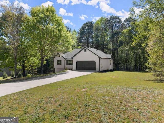 ranch-style house with a garage, driveway, and a front lawn