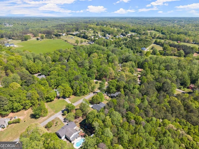 aerial view featuring a wooded view