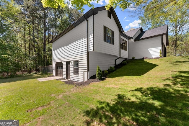 view of home's exterior featuring a garage and a yard