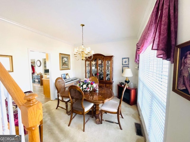 dining room featuring light colored carpet, ornamental molding, a notable chandelier, and visible vents