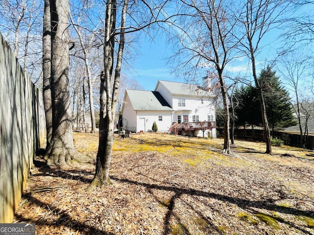 exterior space featuring fence and a wooden deck