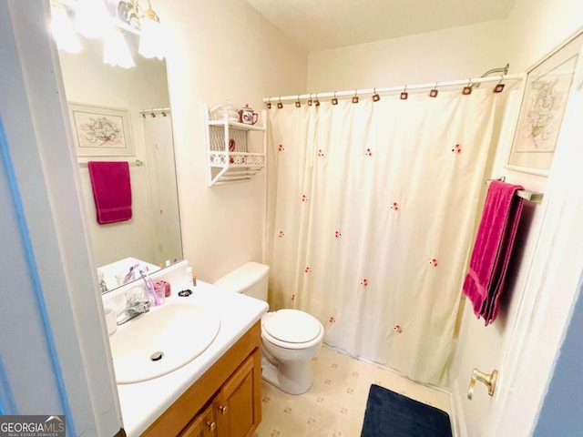 full bathroom with curtained shower, tile patterned floors, vanity, and toilet