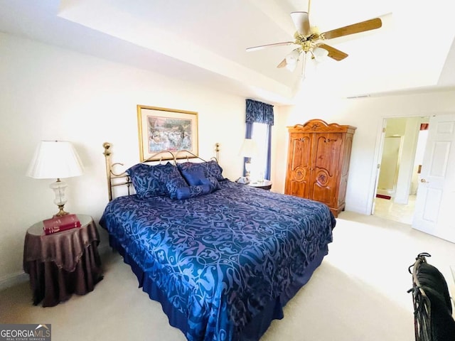 bedroom featuring baseboards, a ceiling fan, a tray ceiling, and carpet floors