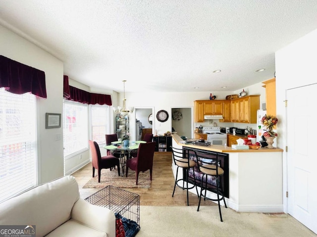 dining space featuring recessed lighting, a textured ceiling, and baseboards