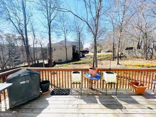 wooden deck with a grill