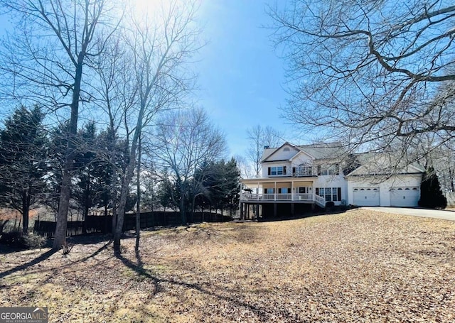 view of front facade with an attached garage, driveway, and a porch