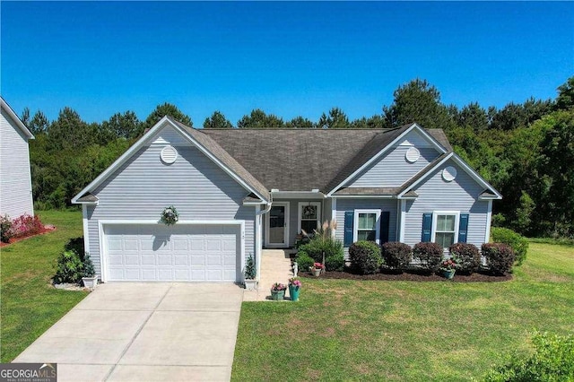 view of front of house featuring an attached garage, a front lawn, and driveway