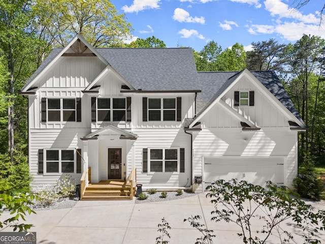 view of front of property with board and batten siding, roof with shingles, and driveway