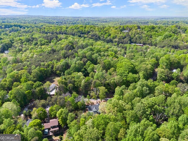 birds eye view of property featuring a forest view