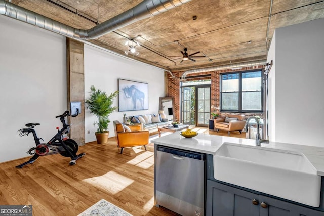 3180 Mathieson Dr NE Unit 703, Atlanta, GA 30305 - kitchen with open floor plan, stainless steel dishwasher, a sink, and light wood-style flooring