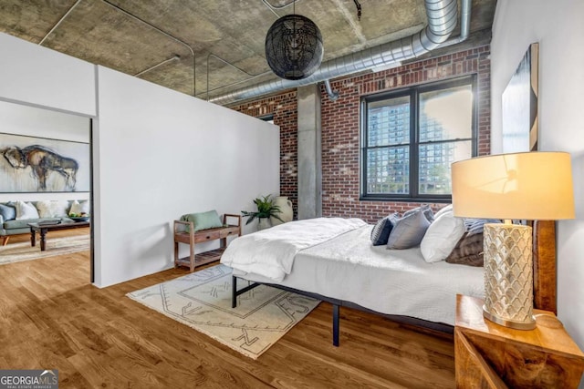 3180 Mathieson Dr NE Unit 703, Atlanta, GA 30305 - bedroom with brick wall and wood finished floors