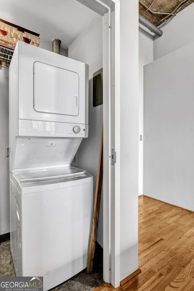 3180 Mathieson Dr NE Unit 703, Atlanta, GA 30305 - clothes washing area featuring wood finished floors, stacked washer and clothes dryer, and laundry area