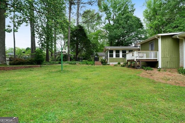 view of yard featuring a wooden deck