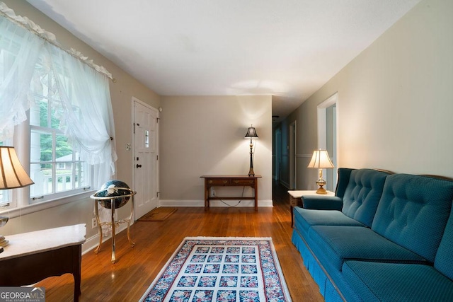 living area with wood finished floors and baseboards