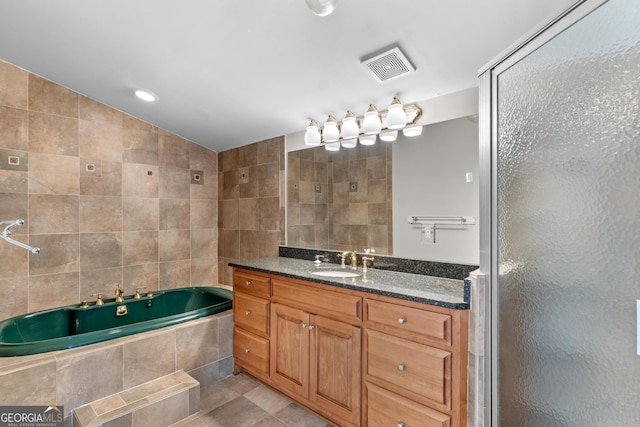full bath featuring vanity, tile walls, a shower stall, visible vents, and a bath