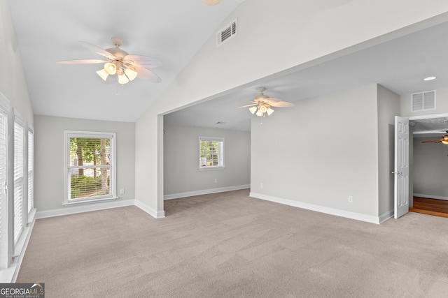unfurnished living room with carpet flooring, ceiling fan, visible vents, and lofted ceiling