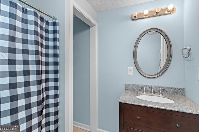 bathroom with vanity, a textured ceiling, and a shower with shower curtain