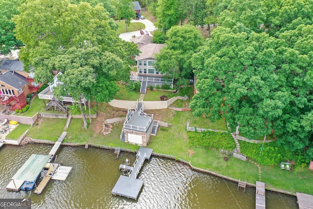 view of home's exterior with a chimney, a shingled roof, a water view, and stone siding