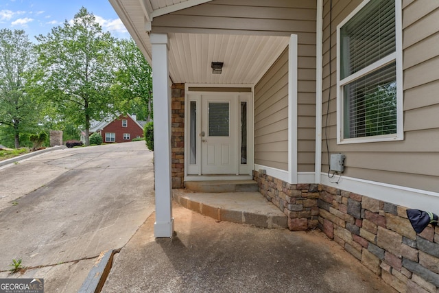 doorway to property with stone siding