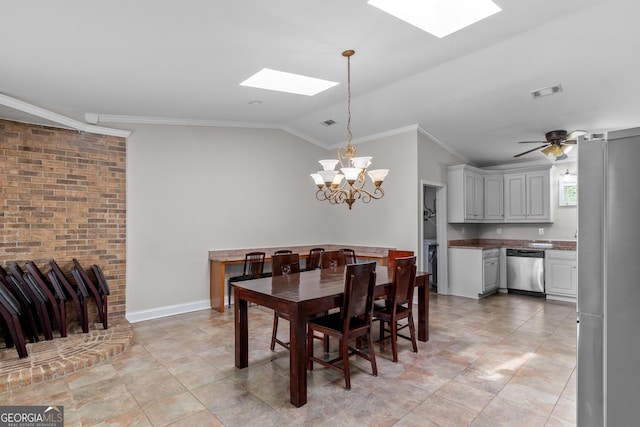 dining room with visible vents, ornamental molding, light tile patterned flooring, lofted ceiling with skylight, and a chandelier