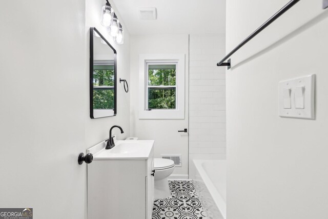 bathroom featuring toilet, visible vents, tile patterned flooring, washtub / shower combination, and vanity