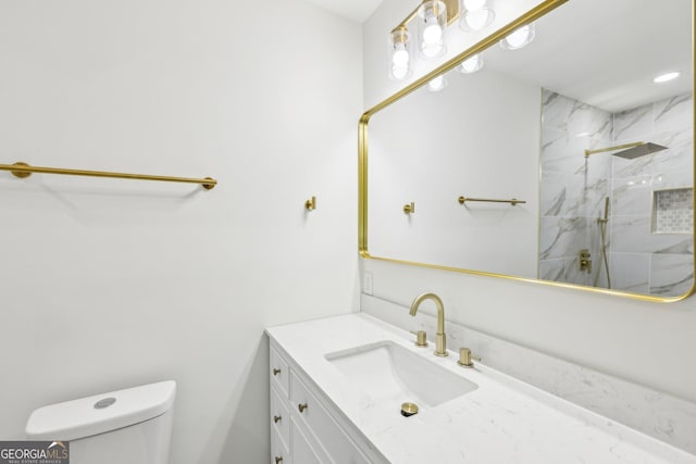 full bath with toilet, vanity, and a marble finish shower
