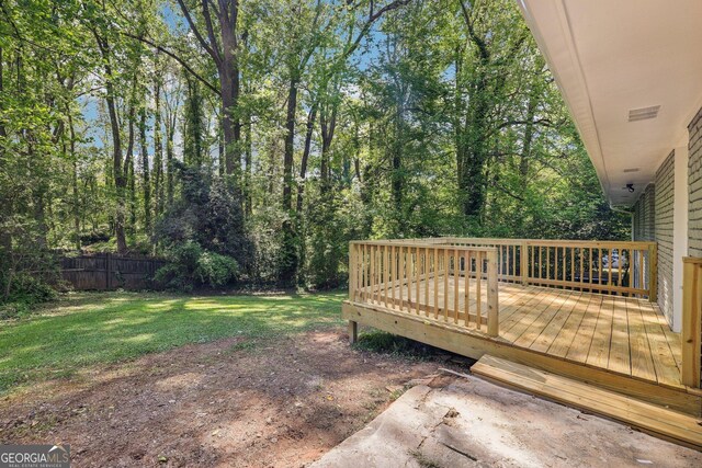view of yard with fence and a wooden deck