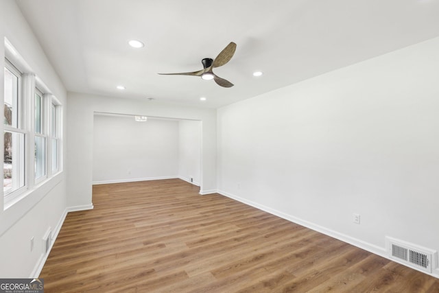 unfurnished room featuring ceiling fan, light wood finished floors, baseboards, visible vents, and recessed lighting