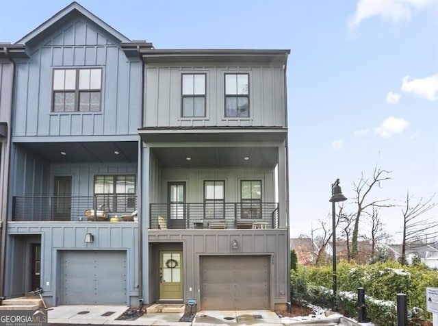 200 Chestnut Cir, Atlanta, GA 30342 - townhome / multi-family property featuring board and batten siding, an attached garage, driveway, and a balcony