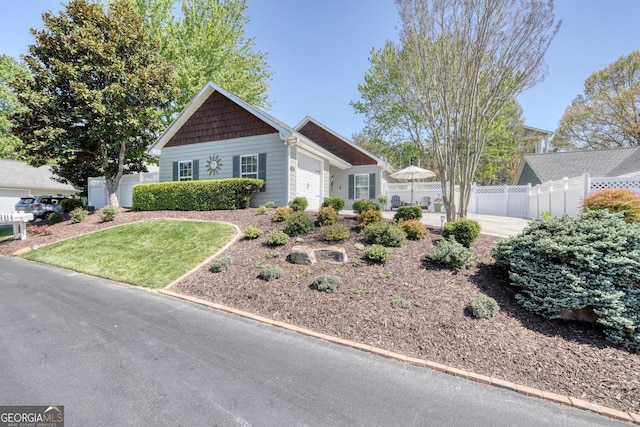 view of front facade featuring a garage and fence
