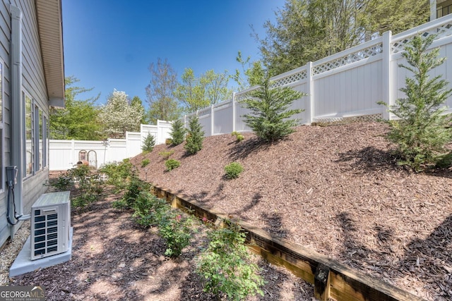 view of yard featuring a fenced backyard and ac unit