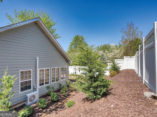 view of home's exterior featuring fence and ac unit