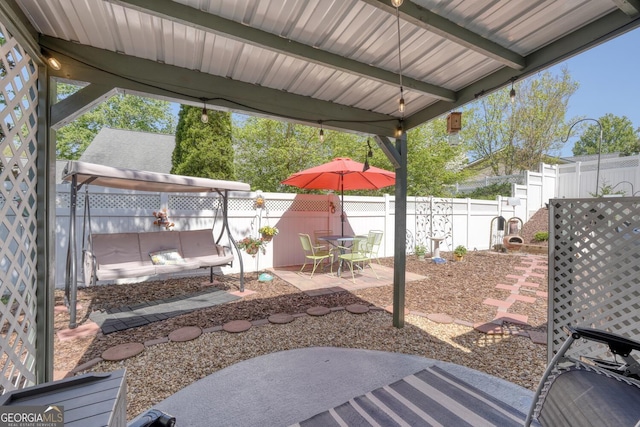 view of patio featuring a fenced backyard and outdoor dining area