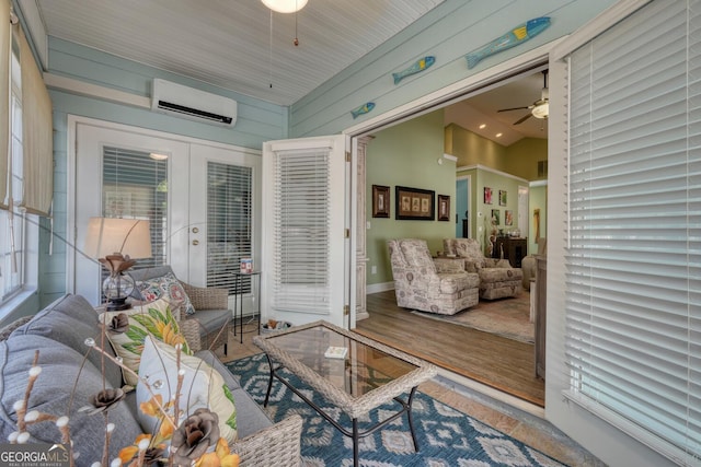 sunroom featuring french doors and an AC wall unit