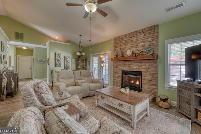 living area with baseboards, a ceiling fan, and visible vents