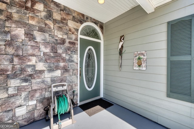 view of exterior entry featuring stone siding