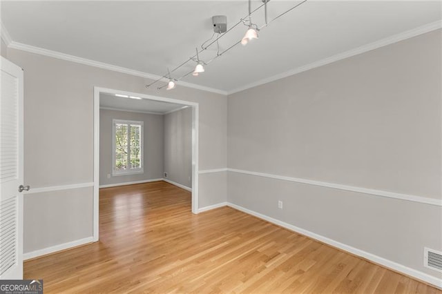 4044 Ashentree Dr, Brookhaven, GA 30341 - unfurnished dining area featuring baseboards, crown molding, visible vents, and light wood-style flooring