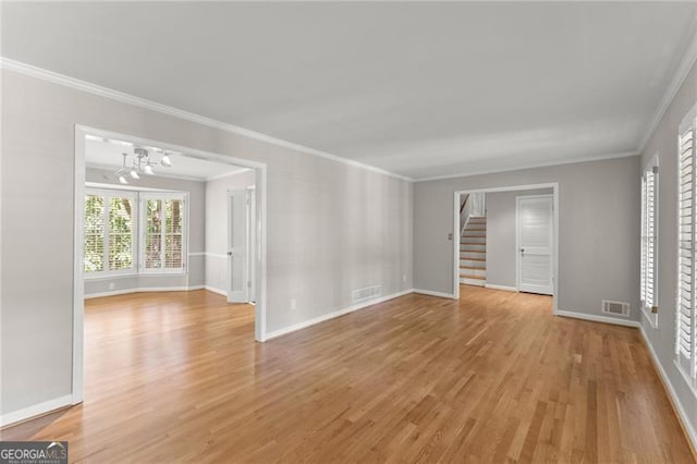 4044 Ashentree Dr, Brookhaven, GA 30341 - interior space with crown molding, stairs, light wood-style flooring, a notable chandelier, and visible vents