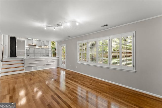 4044 Ashentree Dr, Brookhaven, GA 30341 - unfurnished living room with wood finished floors, a wealth of natural light, crown molding, and baseboards