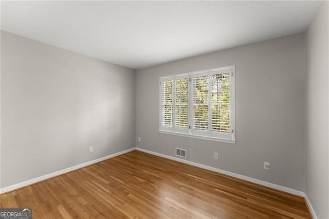 4044 Ashentree Dr, Brookhaven, GA 30341 - unfurnished room featuring baseboards, visible vents, and light wood-style flooring