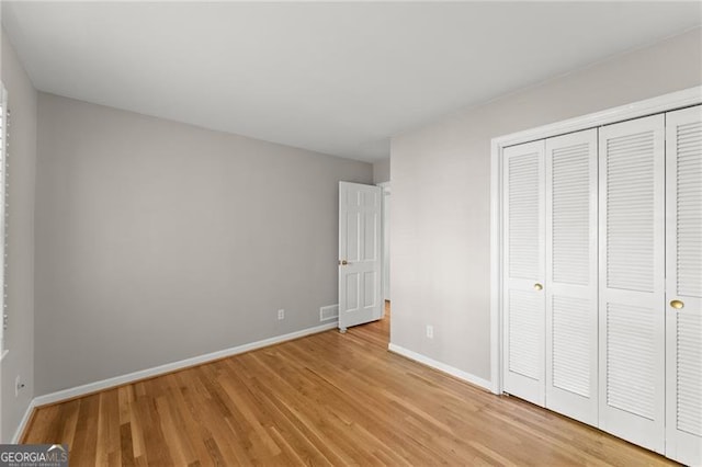 4044 Ashentree Dr, Brookhaven, GA 30341 - unfurnished bedroom with a closet, light wood-style flooring, visible vents, and baseboards