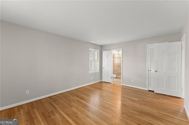 4044 Ashentree Dr, Brookhaven, GA 30341 - unfurnished bedroom with light wood finished floors, baseboards, and ensuite bathroom