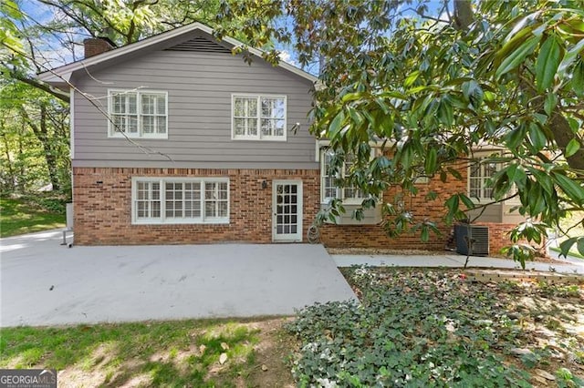 4044 Ashentree Dr, Brookhaven, GA 30341 - rear view of property featuring brick siding, a patio area, and a chimney