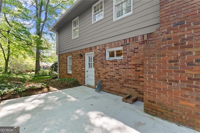 4044 Ashentree Dr, Brookhaven, GA 30341 - back of house featuring brick siding and a patio area