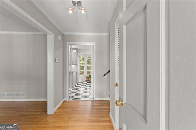 4044 Ashentree Dr, Brookhaven, GA 30341 - foyer entrance with crown molding, visible vents, light wood finished floors, and baseboards