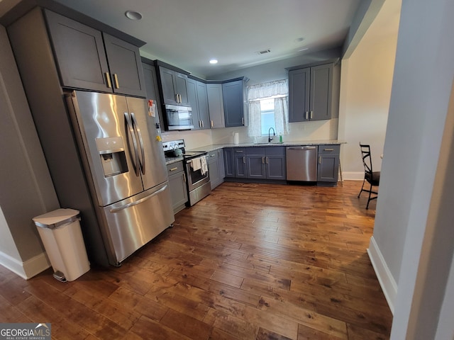 475 Willard Ave SW, Atlanta, GA 30310 - kitchen with dark wood-style flooring, appliances with stainless steel finishes, a sink, and baseboards