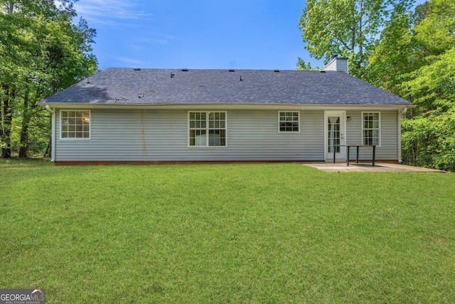 1012 Miss Amber Way, Locust Grove, GA 30248 - rear view of house featuring a patio, a chimney, a lawn, and a shingled roof