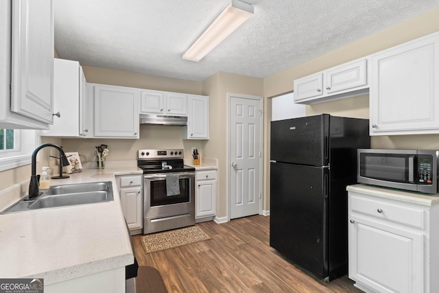 1012 Miss Amber Way, Locust Grove, GA 30248 - kitchen with stainless steel appliances, under cabinet range hood, a sink, wood finished floors, and light countertops